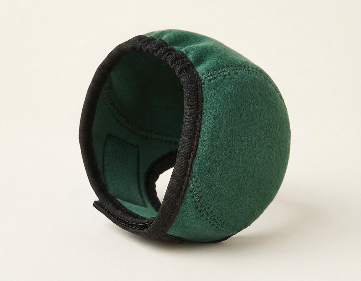 Dark green noise-reducing dog ear defenders, studio photo