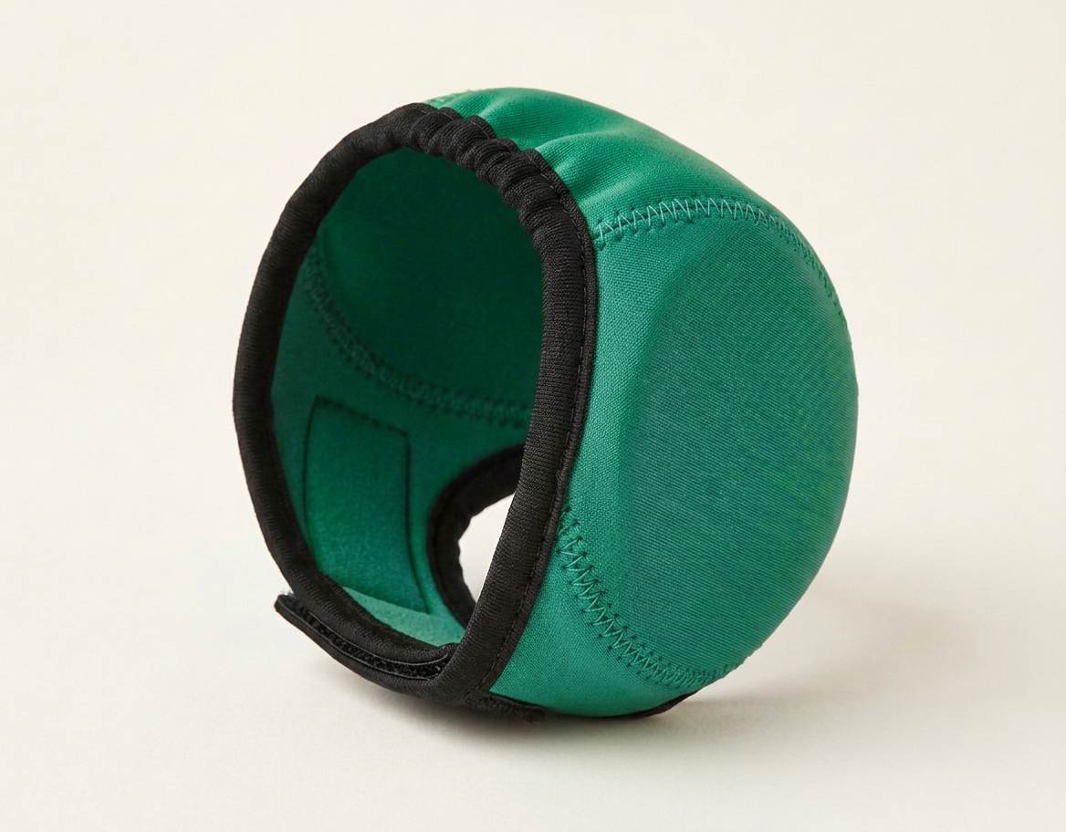 Green noise-reducing dog ear defenders, studio photo