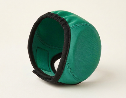 Green noise-reducing dog ear defenders, studio photo