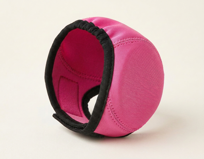 Pink noise-reducing dog ear defenders, studio photo